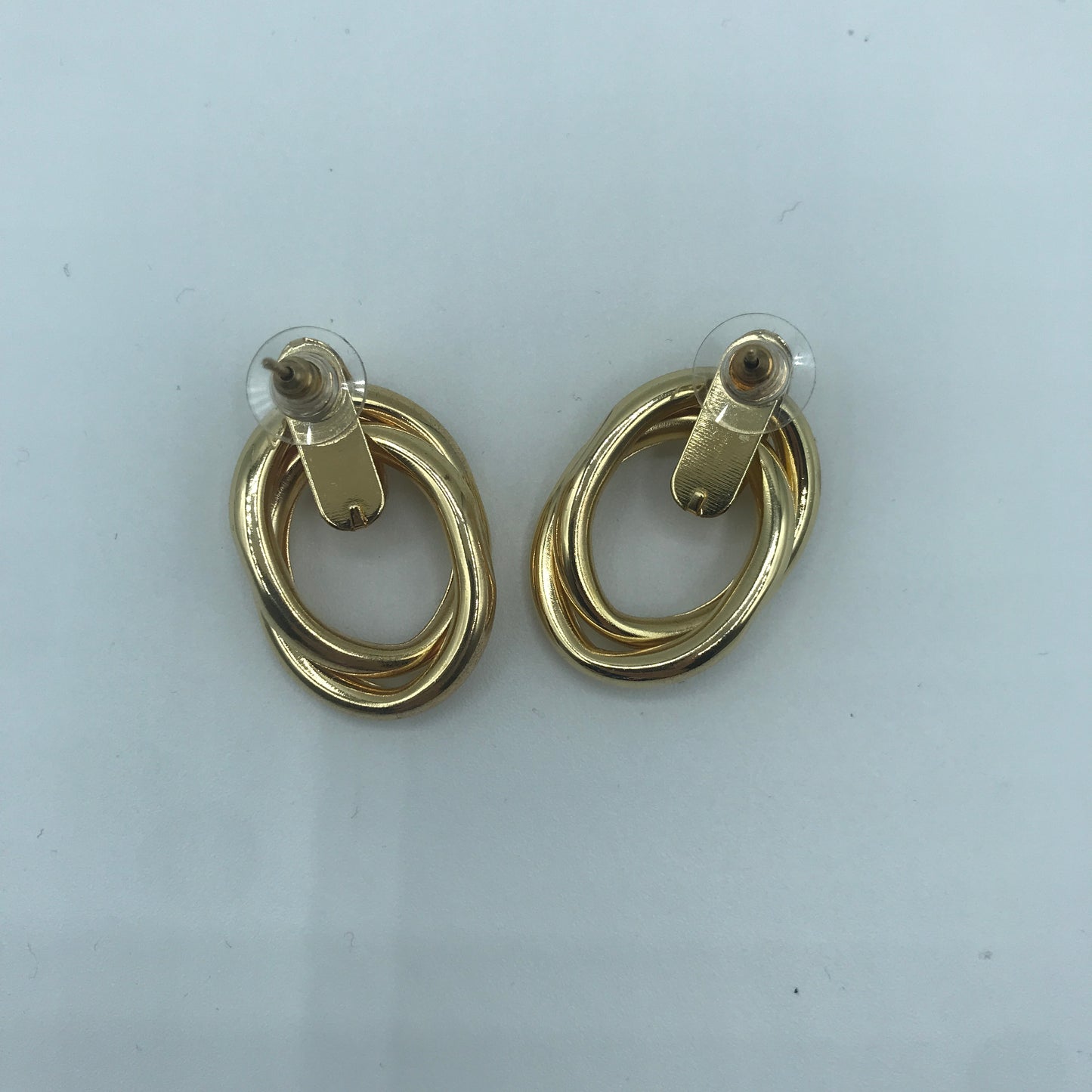 Crossed oval hoop earrings